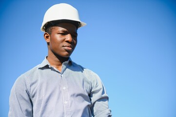 African American worker in a construction helmet