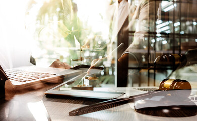 Business and lawyers discussing contract papers with brass scale on desk in office. Law, legal services, advice, justice and law concept