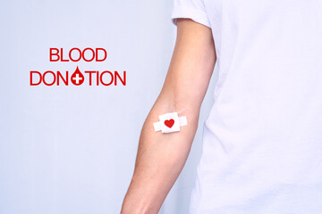 World blood donor day. Blood donation. Blood donor with bandage after giving blood