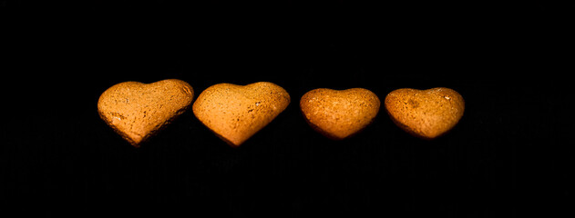 Heart-shaped cookies in descending order isolated on a black background