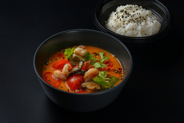 tom yam on a black background