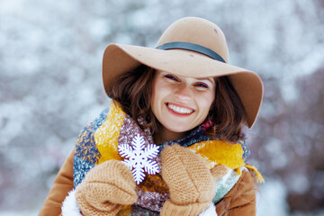 smiling stylish woman outdoors in city park in winter