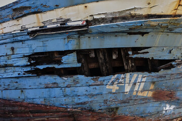  hull of a wooden ship worn by the passage of time.  
