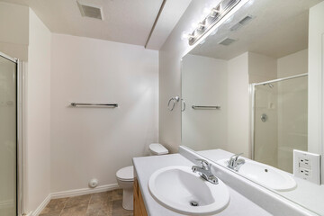 Fototapeta na wymiar Bathroom with tiles flooring and vanity sink with mirror