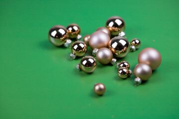 Christmas composition of golden balls on a green background.
