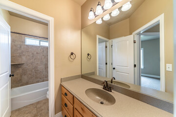 Master bathroom with light brown theme color and white doors