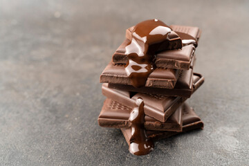 melted chocolate pouring into a piece. Chocolate tower pieces. recipe Cooking handmade chocolate bar, dessert, candies. Confectionery covered with chocolate topping
