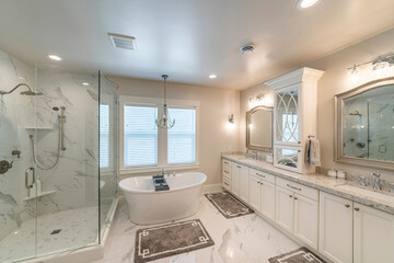 Luxurious master bathroom with marble tiles and window