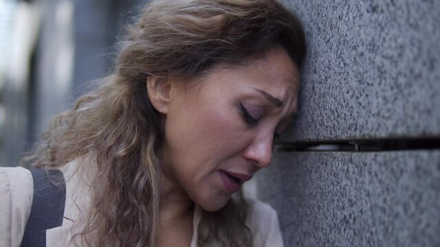 Sad young woman crying after job interview failure, upset with problem at work