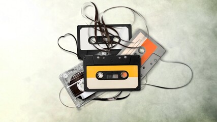 Old audio cassettes on confused audio tape on the desk