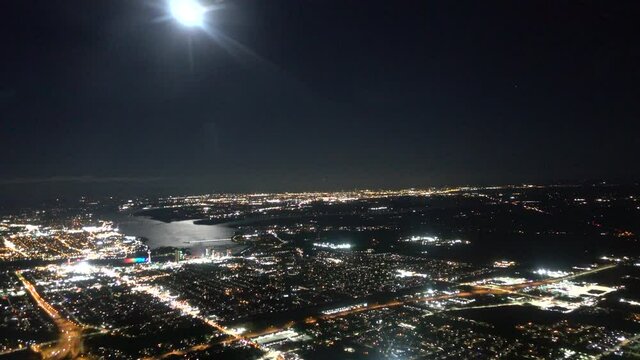 Airplane Aerial With Full Moon In Sky Flying Over City Area Towards New York Niagara Falls Evening