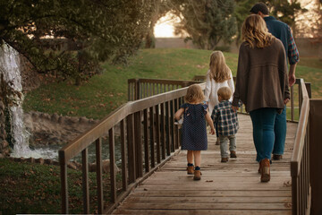 Family Waking on Wooden Bridge Together Holding Hands Fun Sweet Pretty Beautiful Background Loving 