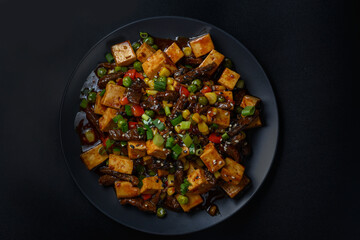 fried tofu on a black background