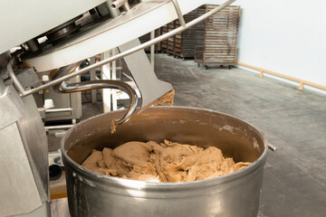 Making dough for bread in a kneader in a bakery. Industrial mixer for kneading dough. One of the...