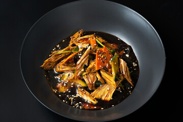 asian salad with asparagus on a black background