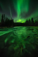 Fotobehang The aurora borealis reflects in the water over the Chatanika River, Alaska.  © David W Shaw