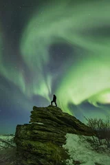 Foto op Plexiglas A silhouette of a person watching the aurora borealis near Fairbanks, Alaska. © David W Shaw