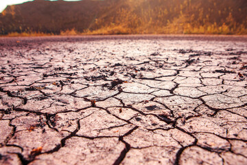Cracked red earth during drought, the texture of earth during drought. A long time without rain....