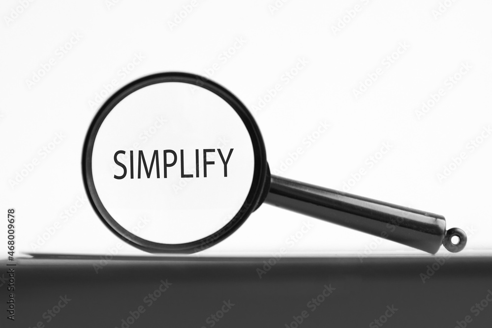 Poster magnifying glass with text simplify on notebook