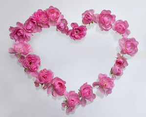 Valentine background. Heart shaped bouquet of beautiful pink rose flowers