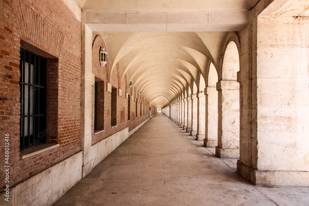 Poster scenic view of a walking path enclosed with pillars and walls
