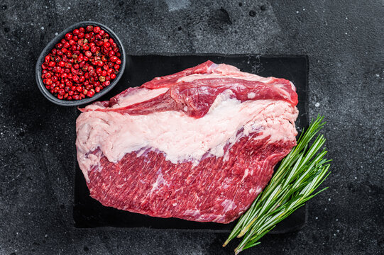 Raw Outside Round Roast Beef Meat Cut On A Marble Board. Black Background. Top View