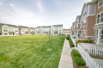 Large lawn field in the middle of townhouse buildings