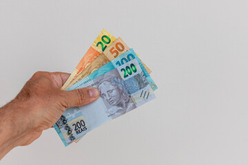 Brazilian money bills in hand