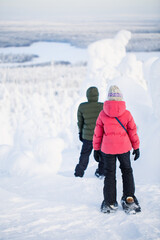 Teenaders hiking in snowshoes