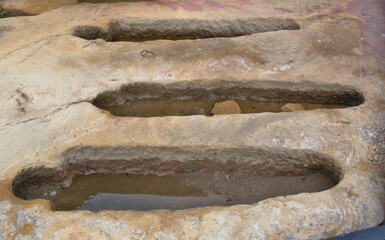 Detail of three anthropomorphic tombs carved out of the sandstone. Necropolis of the village...