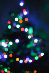 Obraz na płótnie Canvas Abstract christmas tree bright lights bokeh. New year festive mood background. New Years Eve 2022.