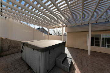 Covered portable spa pool at the backyard of a house