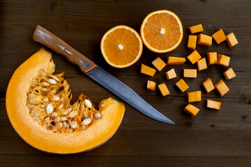 Fresh organic pumpkin slice, cut oranges and a knife