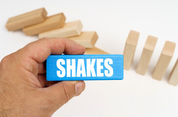 The man is holding a blue plaque with the inscription - shakes