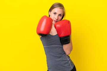 Young English woman isolated on yellow background with boxing gloves