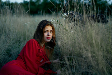 woman in red dress lies on the grass nature freedom rest