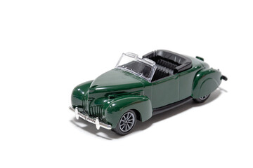 Dark green vintage car isolated on white background