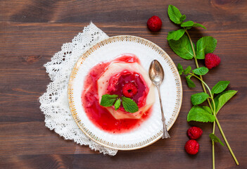 Sweet delicious raspberry mousse jelly on wooden table