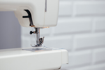 Close-up of the sewing machine and sewing needle studio. macro