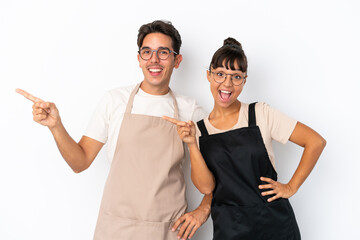 Restaurant mixed race waiters isolated on white background pointing finger to the side and presenting a product