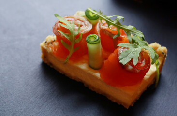 Tasty salmon sandwich on dark background