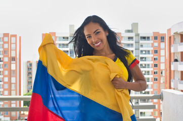 Cheerful woman with Colombian flag. Colombian soccer, Colombia national team,
