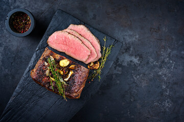 Traditional Commonwealth Sunday roast with sliced cold cuts roast beef with garlic and salt as top...