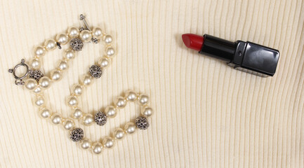 Pearls and Red Lipstick on Cream Colored Sweater Closeup