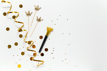 gold stars, crown and tinsel on a white background