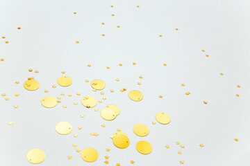 golden confetti and glitter stars on white background