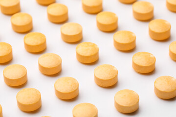 Many vitamin A pills on white background, closeup