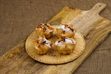 Obraz na płótnie Canvas Traditional italian pastries soffioni on a cutting rustic board.