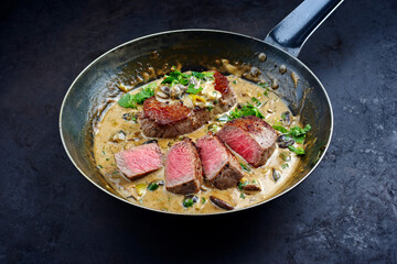 Traditional barbecue dry aged angus roast beef steak natural with mushrooms and onions in cream...