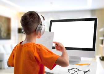 Small junior school kid student using digital computer